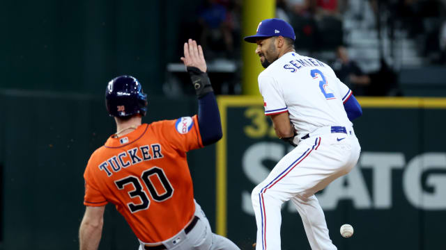 Texas Rangers second baseman Marcus Semien drops the ball as Houston Astros right fielder Kyle Tucker slides into second during the fifth inning of Game 5 of the ALCS Friday at Globe Life Field.